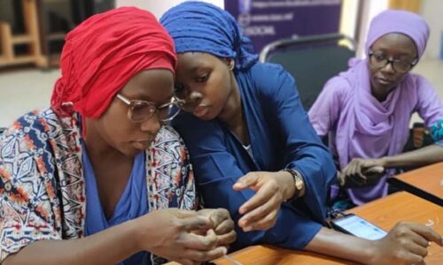 Three women sit in a DDCN class