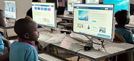 A child in classroom in front of a computer