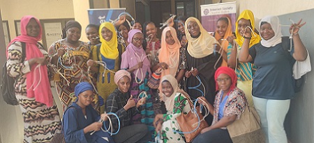 A group of women posing for a photo with cables in their hands