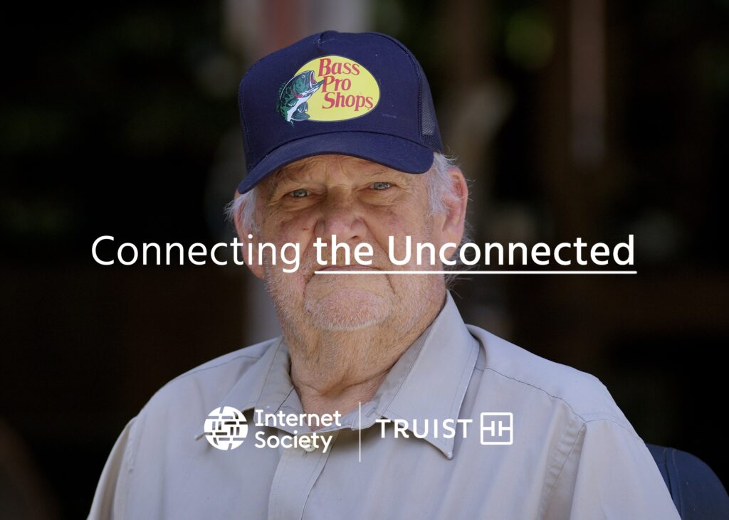 A man in a blue hat looks at the camera. Text reads: Connecting the Unconnected.