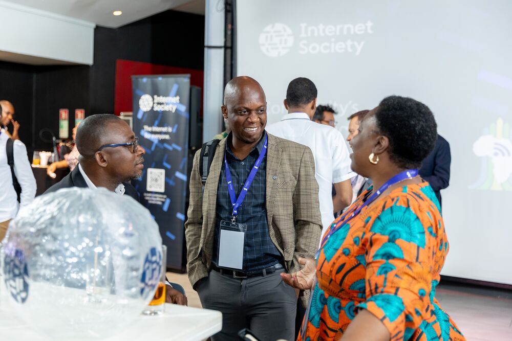 A group of individuals engaged in conversation at a lively event