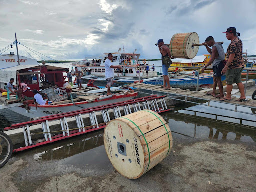 Reels of fiber loaded onto a boat bound for an island six hours off the coast of Quezon, Philippines.