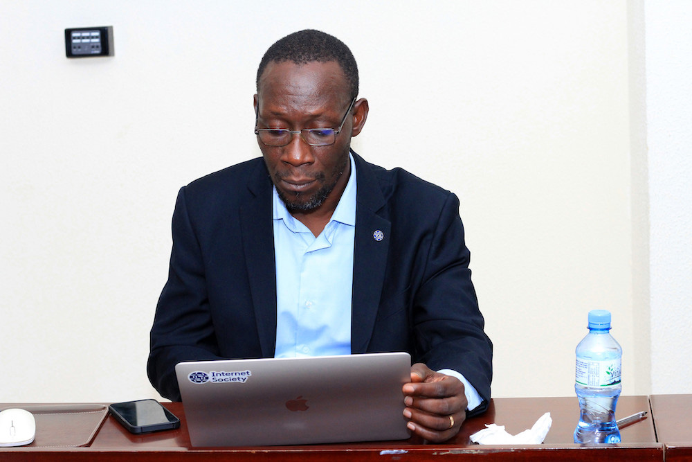 Jean-Baptiste Millogo sits at a computer.